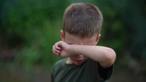 Upset boy wiping tears with his hand. Childish resentment Stock Footage 207242565