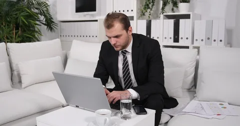 Upset Business Man Working on Computer Laptop and Look on Pie Chart Sit on Sofa Stock Footage 88008768