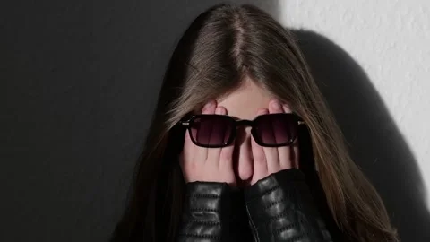 Upset child covers her face with her hands Stock Footage 229923947