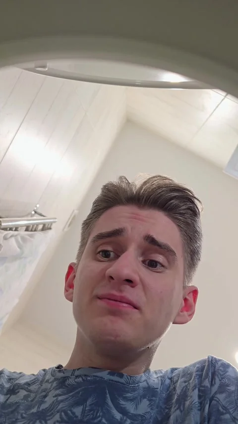 Upset confused man looking under toilet lid, close up Stock Footage 296019030