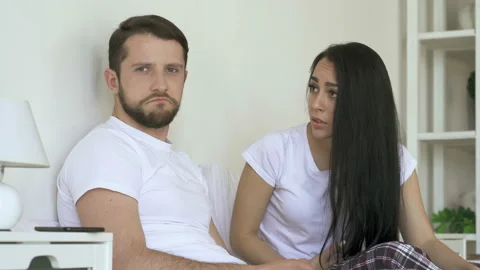 Upset couple talking at the bed. Girlfriend trying to talk with boyfriend. Stock Footage 107434694