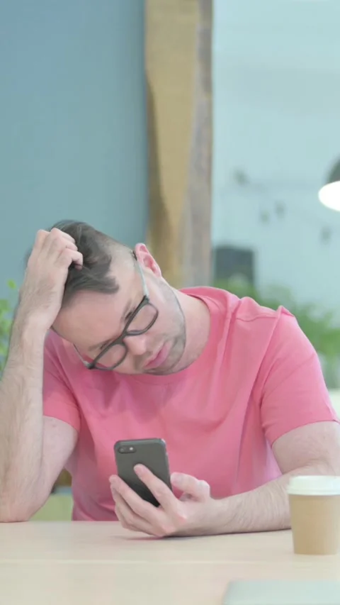 Upset Creative Old Man Reacting to Loss on Smartphone, vertical video Stock Footage 329106348