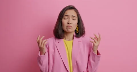 Upset dejected brunette young Asian woman has displeased face expression feels Stock Footage 155255077