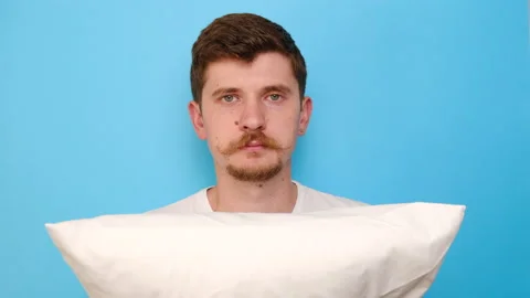 Upset discontent caucasian man feels offended, frowns face, has bad sleep Stock Footage 136625421