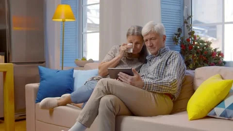 Upset elderly couple receiving bad news on digital tablet at home Video stock 141215032
