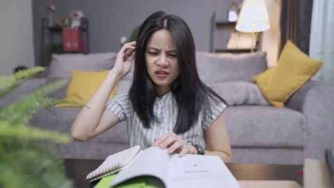 An upset female student getting stressed on hurry deadline of the hard homework 動画素材 157303884