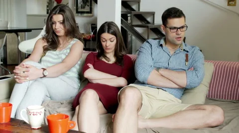 Upset friends sitting on the sofa after quarrel and not talking Видео 54085247