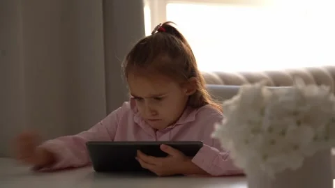Upset Girl Using Tablet. Intensely focused on a gadget Video stock 275646810