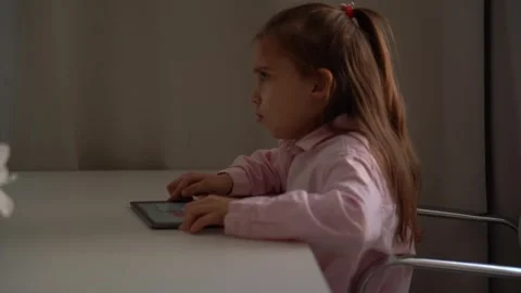 Upset Girl Using Tablet. Intensely focused on a gadget.  school girl Stock Footage 277655851