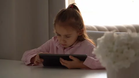 Upset Girl Using Tablet. Intensely focused on a gadget Stock Footage 278600058