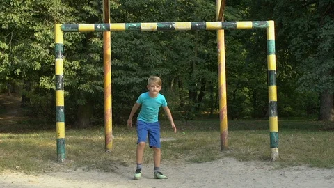 Upset goalkeeper boy trying catch ball gate, active recreation, street game 動画素材 117170414