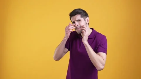 Upset guy look cheeks acne isolated bright color background Stock Footage 187579695