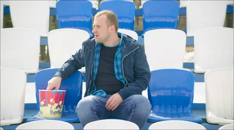 Upset guy sitting on the tribune Stock Footage 63838406