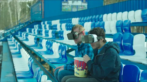 Upset guys in VR glasses sitting at the stadium Stock Footage 63548963