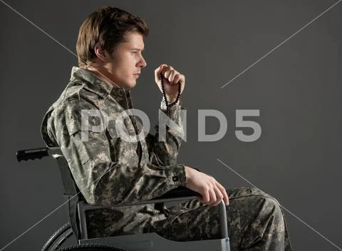 Upset handicapped man wearing military uniform Stock Photos