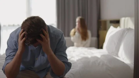 Upset husband feeling stressed and frustrated after a fight with his wife, who Stock Footage 337120251