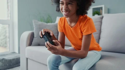 Upset kid lost race speed competition sit couch in apartment flat Stock Footage 168751083
