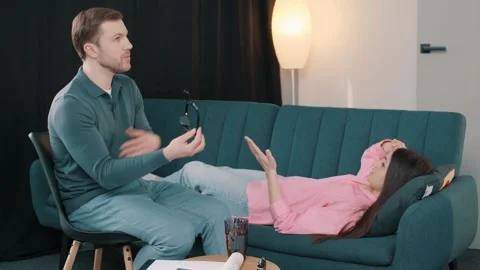 Upset lady lying on sofa and talking with psychologist at therapy session 스톡 동영상 244653207