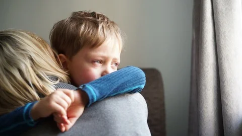 Upset little boy hugging his mother at home Stock Footage