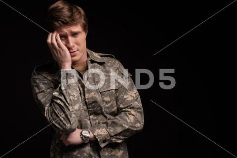 Upset male officer regretting his past Stock Photos