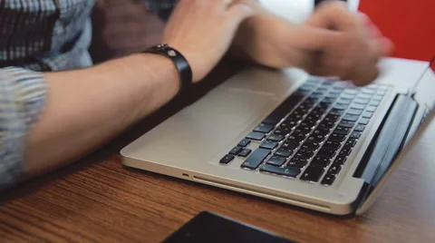 Upset man bangs his head on the laptop keyboard 스톡 동영상 61469437