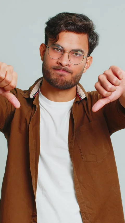 Upset man guy showing thumbs down gesture disapproval dissatisfied dislike Stock Footage 323360332