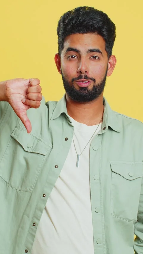 Upset man guy showing thumbs down gesture disapproval dissatisfied dislike Stock Footage 333458941