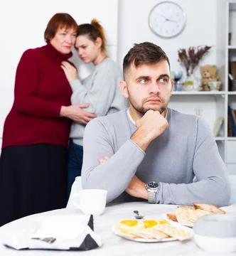 Upset man having problems in relationship with family Stock Photos