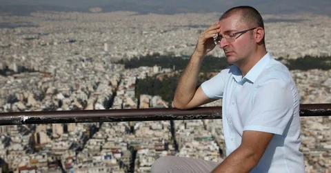 Upset Man Looking Sad Having Serious Headache Pain near City Center Aerial View Stock Footage 83461538