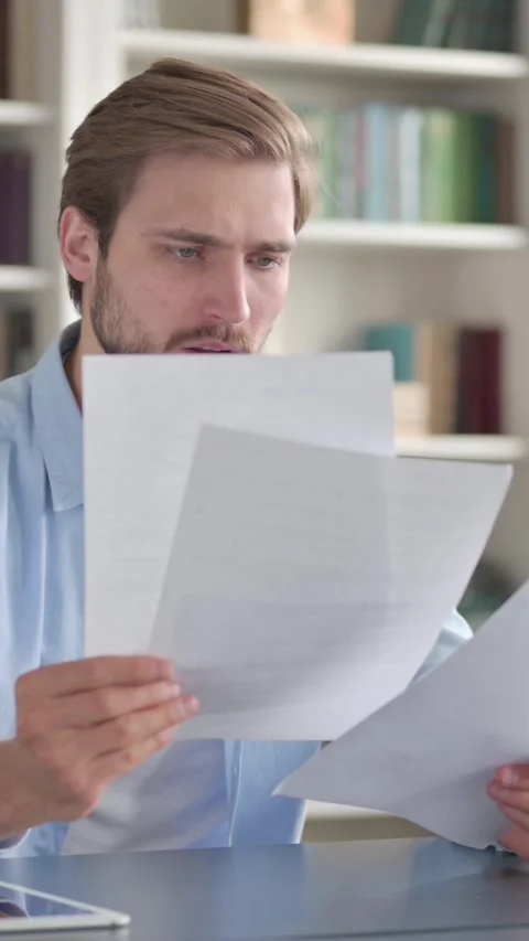 Upset Man Reading Documents, Vertical Video Stock Footage 339578859