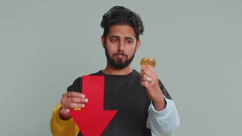 Upset man showing red arrow pointing down, fall of cryptocurrency stock market Stock Footage 238516892