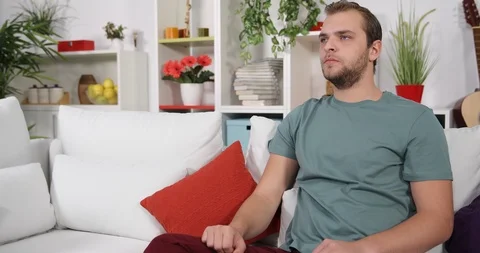 Upset Man Suffer Alone from Headache Pain Having Medical Problem Sitting on Sofa Stock Footage 88014158