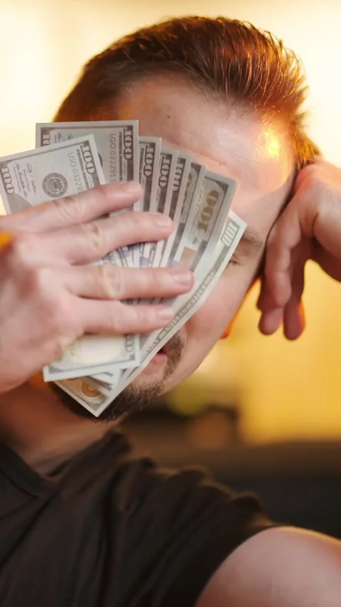 Upset man wipe tears with stack of dollar money banknotes sarcastic meme Stock Footage 324119029