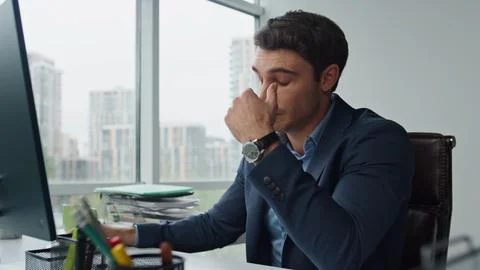 Upset manager analyzing data thinking financial company problems at workplace. Stock Photos