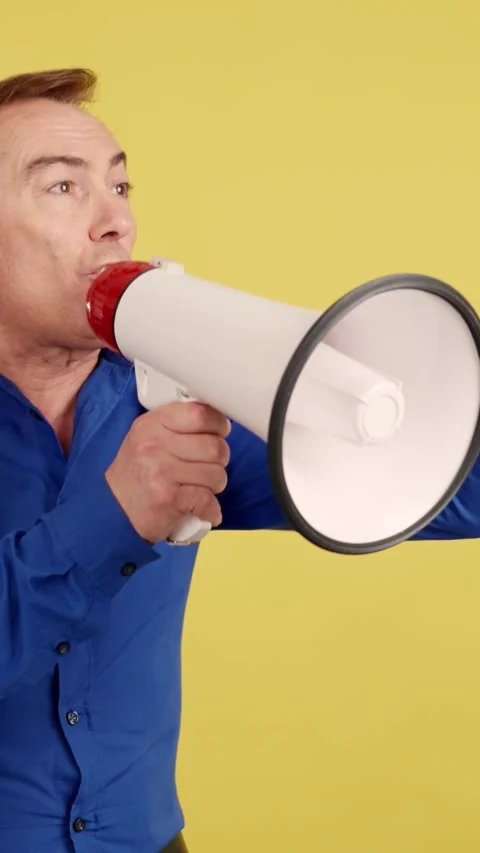 Upset mature man shouting using a loudspeaker Stock Footage 244074522