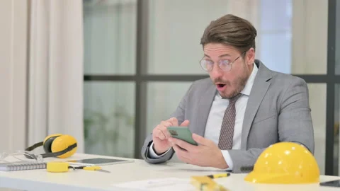Upset Middle Aged Engineer Reacting to Loss on Smartphone Stock Footage 166112100