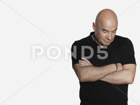 Upset Middle Aged Man With Arms Crossed Stock Photos
