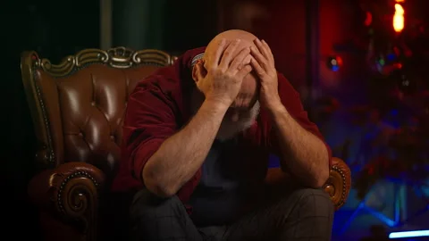 Upset middle-aged man feels lonely and grieves during Christmas holidays Stock Footage 346714232