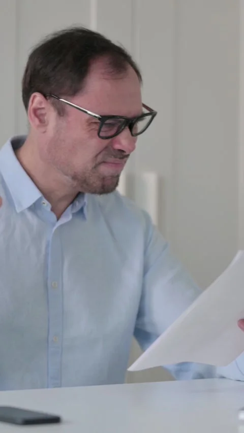 Upset Middle Aged Man Reading Documents, Vertical Video 스톡 동영상 339585171