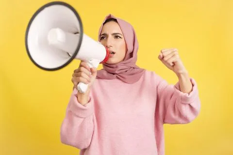 Upset muslim woman using a loudspeaker in anger Stock Photos
