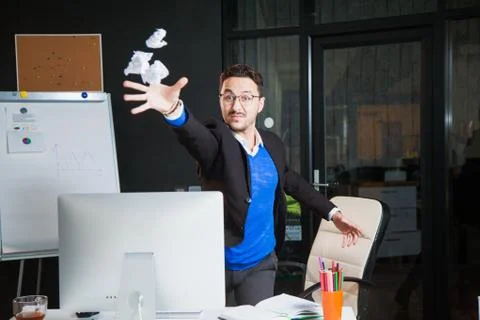 Upset office worker throw paper nervous angry businessman at office. Stock Photos