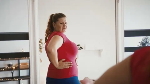 Obese lady in underwear looking at refle, Stock Video