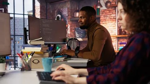 Upset programmer annoyed by computer bugs while coding in IT startup office Foto stock