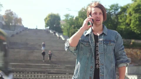 Upset redhead guy talking on the phone Stock-Footage 163364115