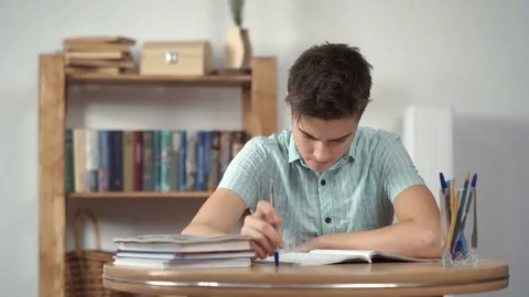 Upset schoolboy doing homework Stock Footage 72128814