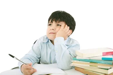 Upset schoolboy doing homework isolated on white Stock Photos