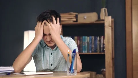 Upset schoolboy struggling while doing homework Stock Footage 72801601