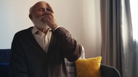 Upset senior man using inhaler during asthma attack, chronic disease struggle Stock Footage 310008725