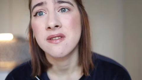 Upset student looking into camera after failed eyeliner attempt Stock Footage 327217300