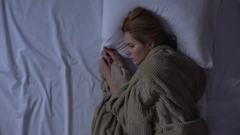 Upset woman crying lying in bed, compressing sheet, pain of boyfriend loss Stock Footage 106232147